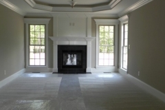 Photo of custom bedroom with fireplace